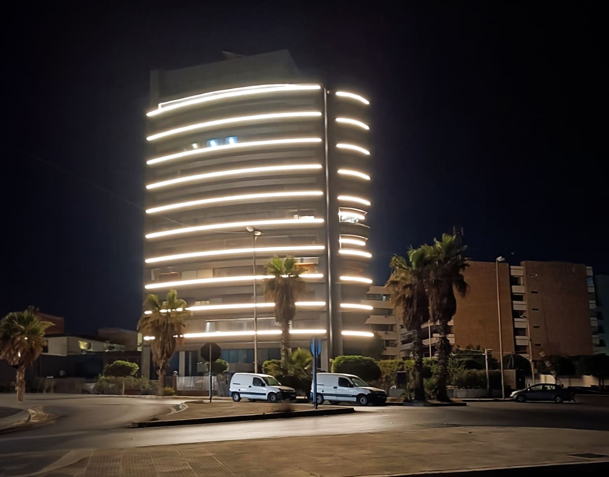 The building’s exterior boasts cool-toned LED illumination, with the LIFELED sign showcasing sharp white and blue thanks to LED technology. This focus on LEDs highlights their ability to create a clean, contemporary aesthetic